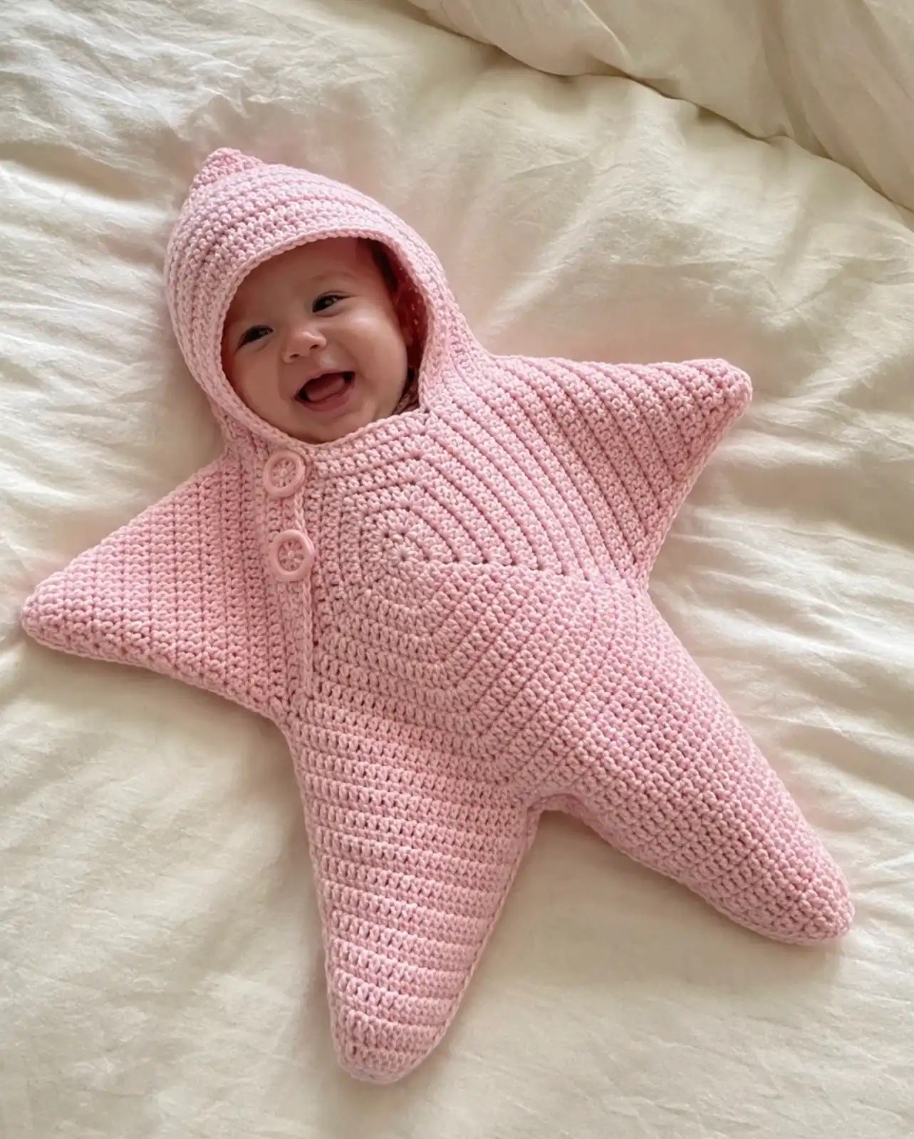 Baby wearing the pink Baby Star Suit