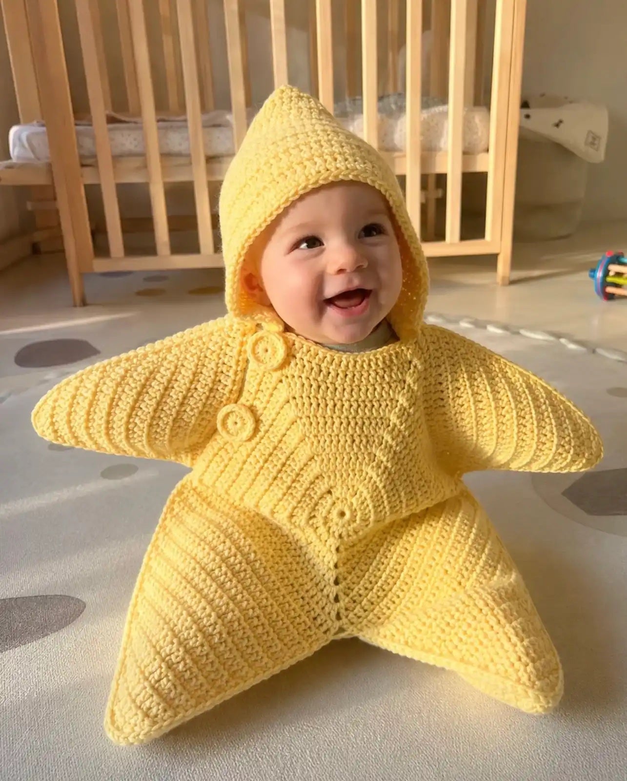 Baby wearing the yellow Baby Star Suit